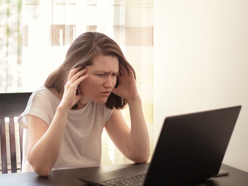 Displeased annoyed woman looking at the laptop