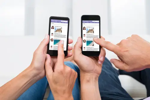 Close-up Of Two People Hands Chatting On Social Networking Site