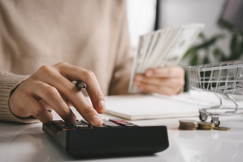 Woman counting and calculate cost money with calculator