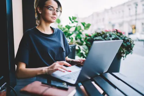 Serious puzzled young manager working on contemporary laptop 