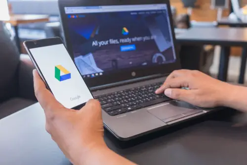 Man hands holding HUAWEI with Google Drive apps on screen