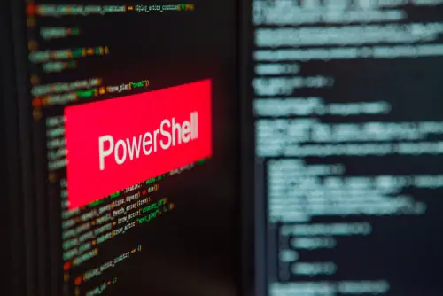 PowerShell inscription on the background of computer code