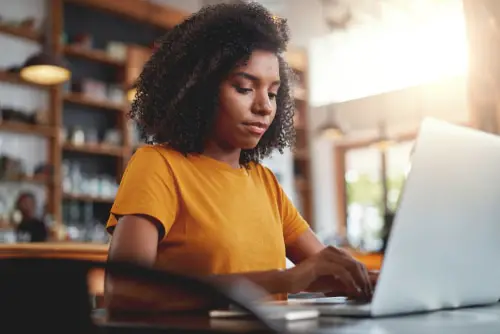 Young afro-american woman working on her laptop