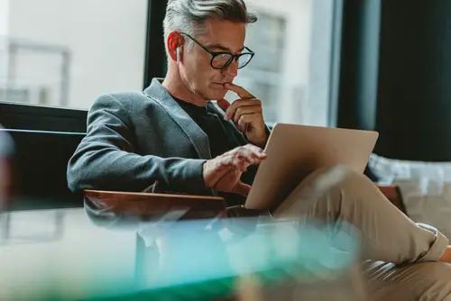 Businessman Looking at Laptop and Thinking.