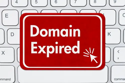 Domain Expired message on a red sign a computer keyboard