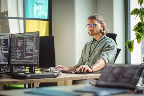 Male Data Scientist Coding on Desktop