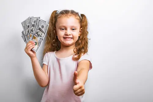 Small professor fun humor kid girl holding dollar money in the hand and showing thumb up sign