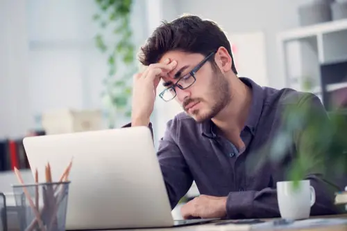 Young Man Working on Computer and Having